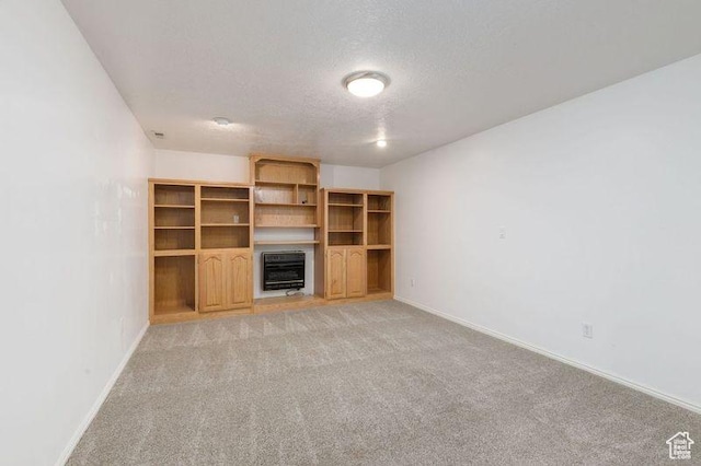 540 N 100 E, Hyde Park, UT 84318 - unfurnished living room with heating unit, a textured ceiling, baseboards, and light carpet