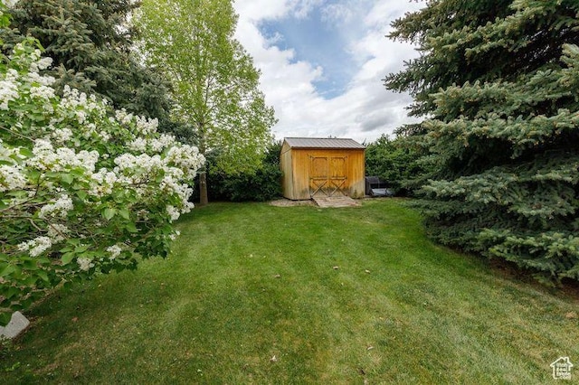 540 N 100 E, Hyde Park, UT 84318 - view of green lawn featuring a storage unit and an outbuilding