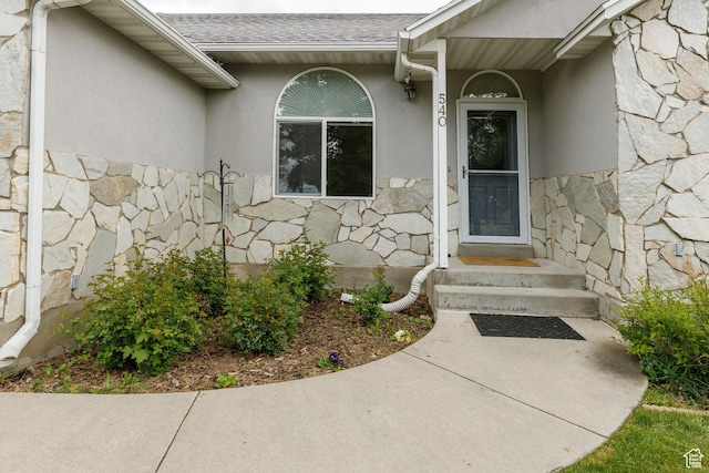 540 N 100 E, Hyde Park, UT 84318 - view of exterior entry featuring stone siding, stucco siding, and a shingled roof