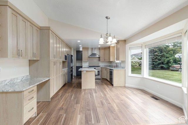 540 N 100 E, Hyde Park, UT 84318 - kitchen with stainless steel appliances, wall chimney exhaust hood, vaulted ceiling, light wood finished floors, and a chandelier