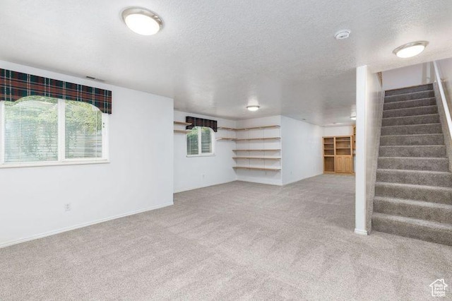540 N 100 E, Hyde Park, UT 84318 - unfurnished living room with carpet floors, stairs, a textured ceiling, and baseboards