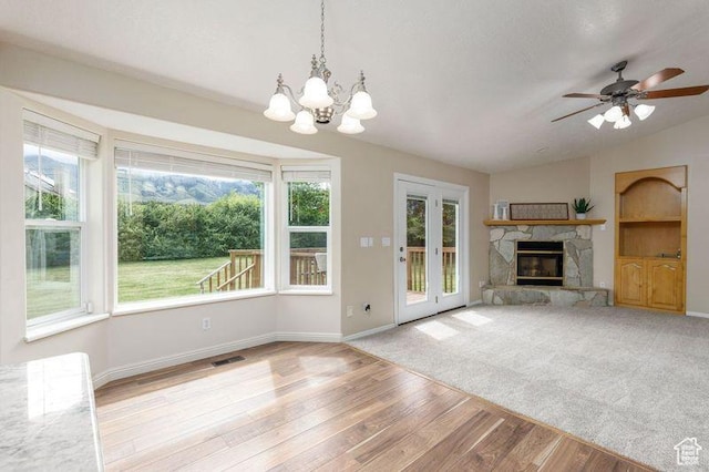 540 N 100 E, Hyde Park, UT 84318 - unfurnished living room with light wood-style floors, baseboards, a fireplace, a chandelier, and vaulted ceiling