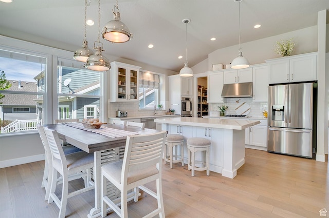 2700 E Red Barn Rd S, Heber City, UT 84032 - kitchen featuring stainless steel appliances, under cabinet range hood, a center island, light countertops, and backsplash