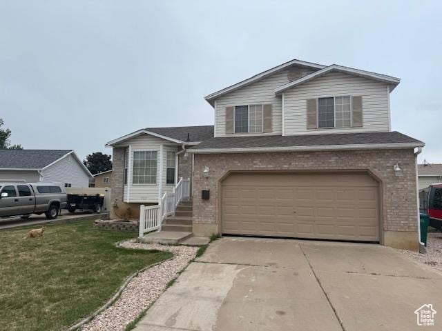 4327 S Westlake W, Roy, UT 84067 - view of front of property with a garage, brick siding, driveway, and a front lawn