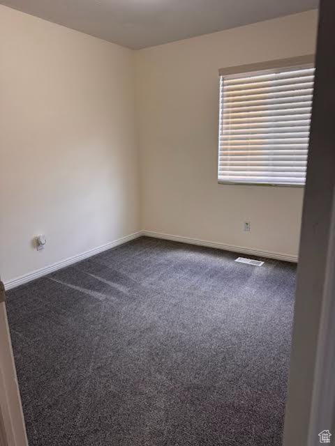 4327 S Westlake W, Roy, UT 84067 - spare room featuring dark colored carpet and baseboards
