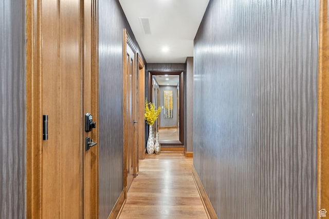 hallway with wood finished floors and baseboards