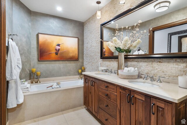 bathroom featuring tile patterned floors, a garden tub, and double vanity