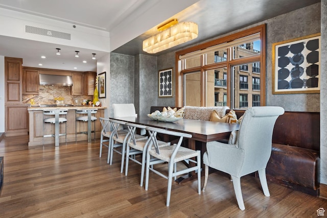 dining space featuring wood finished floors and recessed lighting