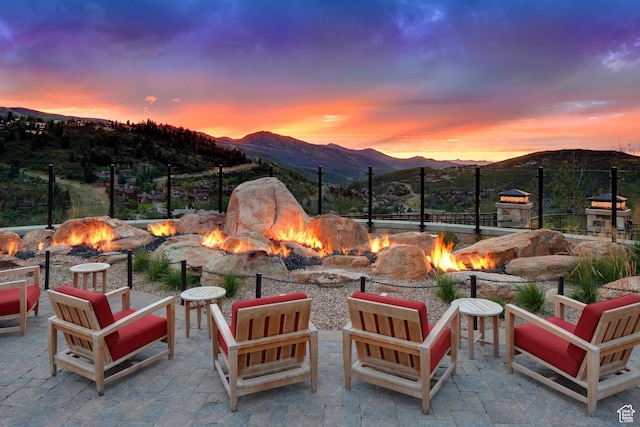 view of patio / terrace featuring an outdoor fire pit and a mountain view
