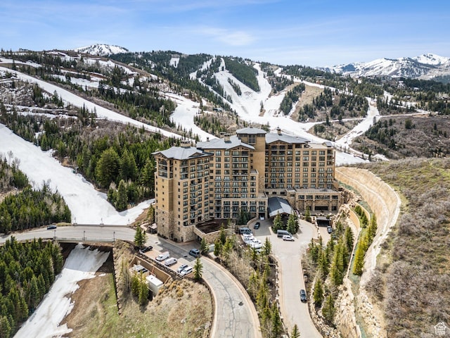 snowy aerial view featuring a mountain view