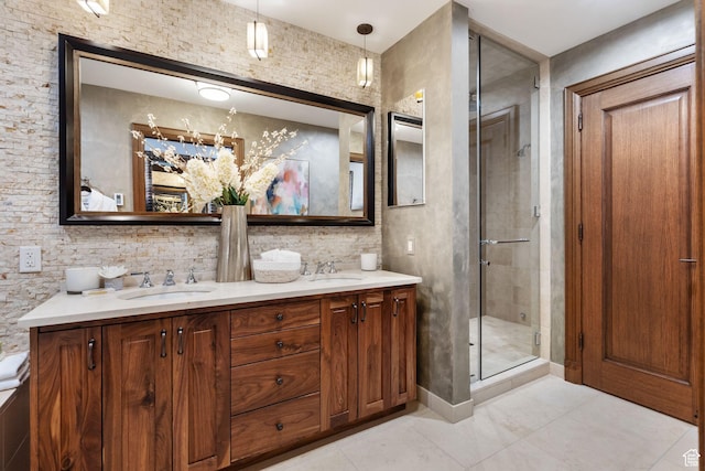 bathroom featuring a shower stall and double vanity