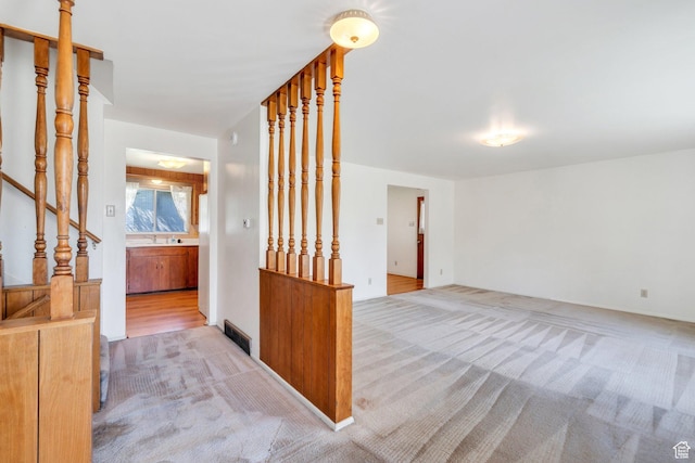 3165 N Bannock Dr E, Provo, UT 84604 - spare room with carpet flooring, a sink, and stairway