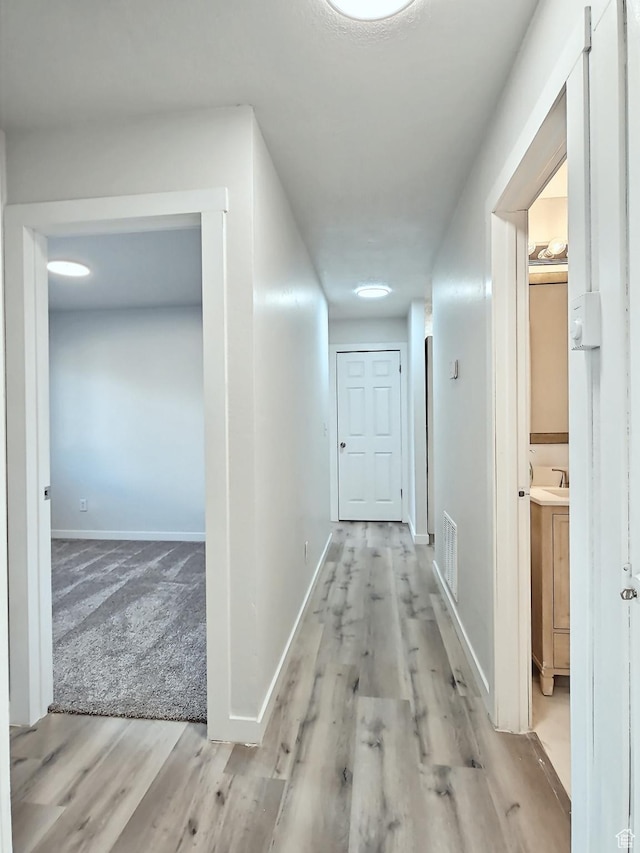 521 N 2400 W, Vernal, UT 84078 - corridor with wood finished floors, baseboards, and a sink