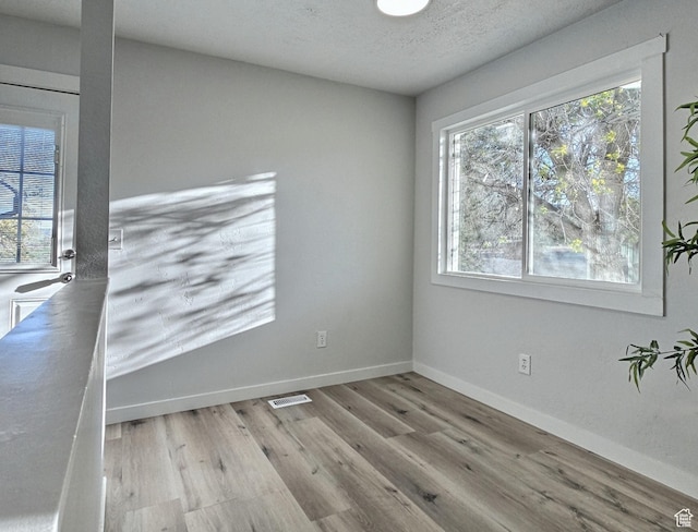 521 N 2400 W, Vernal, UT 84078 - unfurnished room with wood finished floors, baseboards, and a textured ceiling