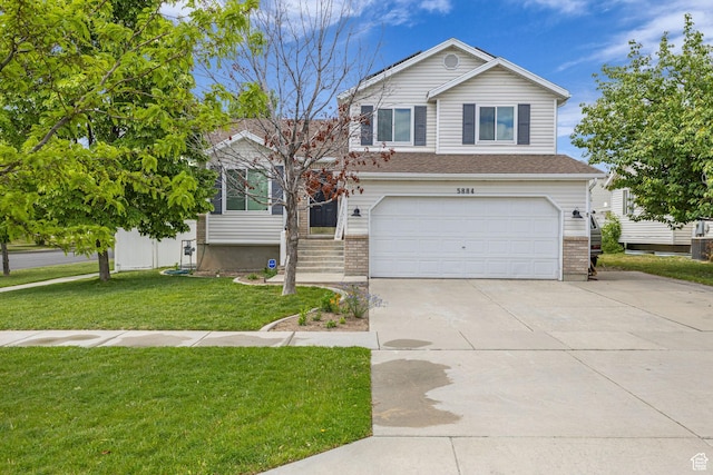 5884 S Impressions Dr W, Salt Lake City, UT 84118 - view of front of house featuring a garage, driveway, a front yard, and brick siding