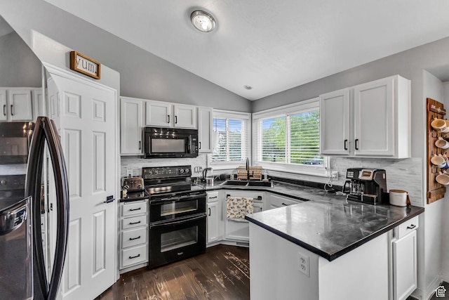 5884 S Impressions Dr W, Salt Lake City, UT 84118 - kitchen with black appliances, a peninsula, a sink, decorative backsplash, and vaulted ceiling