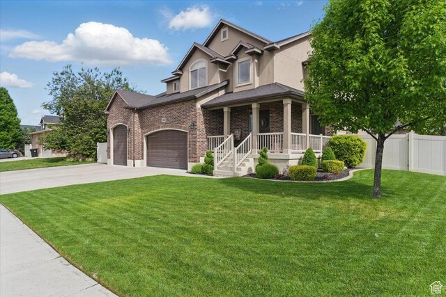view of front of property with driveway, brick siding, covered porch, stucco siding, and a garage