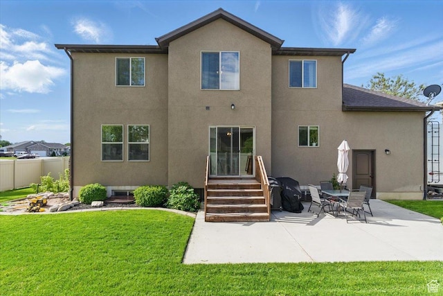 rear view of property featuring stucco siding, a patio area, and entry steps