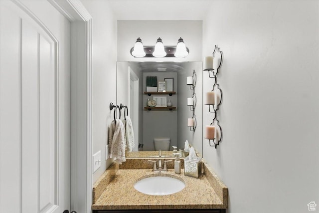 bathroom with toilet and vanity