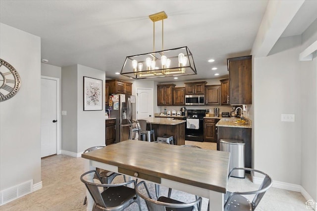 dining area featuring baseboards, recessed lighting, a chandelier, and light tile patterned floors