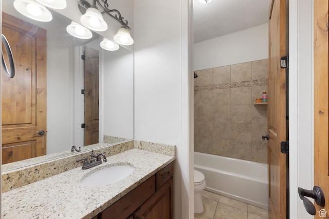 bathroom featuring tile patterned floors, toilet, vanity, and bathtub / shower combination