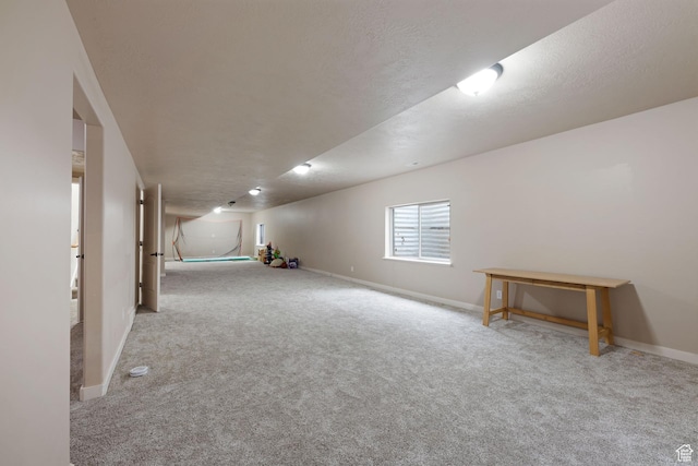 below grade area featuring carpet and baseboards