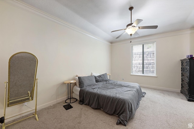 carpeted bedroom with ornamental molding, baseboards, and a ceiling fan