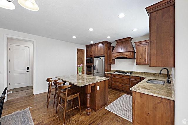 kitchen with premium range hood, a sink, appliances with stainless steel finishes, a center island, and dark wood-style floors