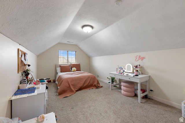 carpeted bedroom featuring lofted ceiling, baseboards, and a textured ceiling
