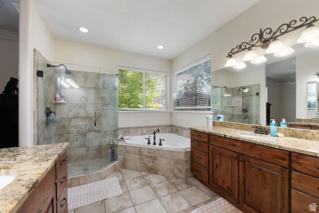 full bath featuring a shower stall, a bath, two vanities, and tile patterned floors