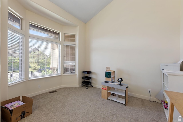 misc room featuring carpet flooring, a desk, and baseboards