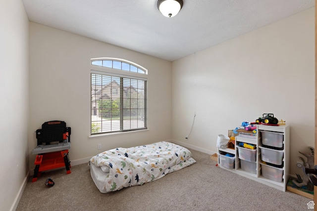 bedroom with carpet floors and baseboards