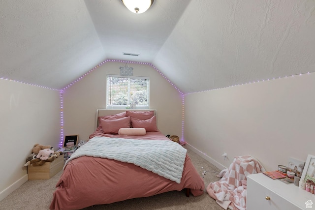 carpeted bedroom with vaulted ceiling and baseboards