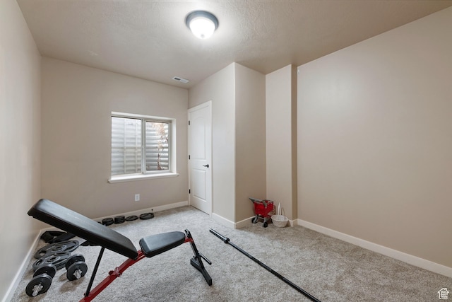 workout area with carpet and baseboards