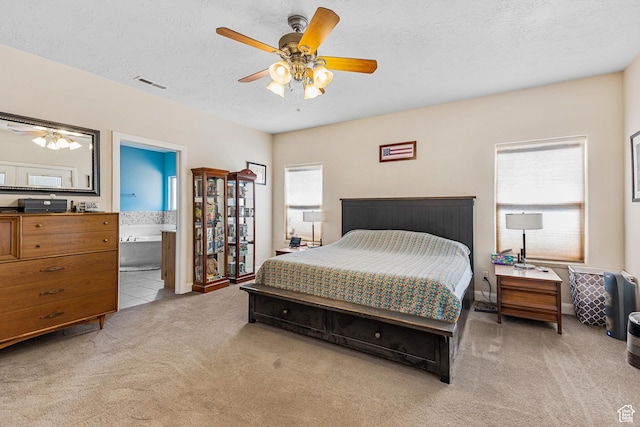 881 W Smithsonian Way, Apple Valley, UT 84737 - bedroom featuring light colored carpet, a textured ceiling, ensuite bath, and ceiling fan