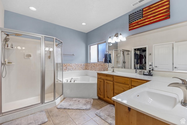 881 W Smithsonian Way, Apple Valley, UT 84737 - bathroom with a shower stall, a bath, tile patterned floors, double vanity, and a spacious closet