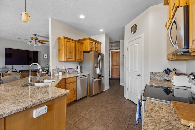 881 W Smithsonian Way, Apple Valley, UT 84737 - kitchen featuring appliances with stainless steel finishes, a sink, ceiling fan, light stone countertops, and open floor plan