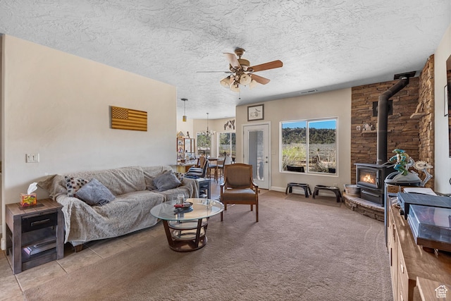 881 W Smithsonian Way, Apple Valley, UT 84737 - living area featuring a wood stove, a ceiling fan, and a textured ceiling