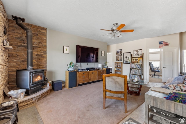 881 W Smithsonian Way, Apple Valley, UT 84737 - living area featuring a wood stove, a ceiling fan, and a textured ceiling