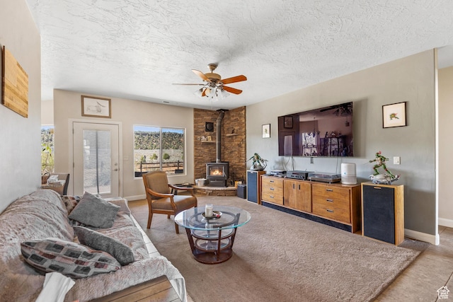 881 W Smithsonian Way, Apple Valley, UT 84737 - living room featuring a wood stove, ceiling fan, baseboards, and a textured ceiling