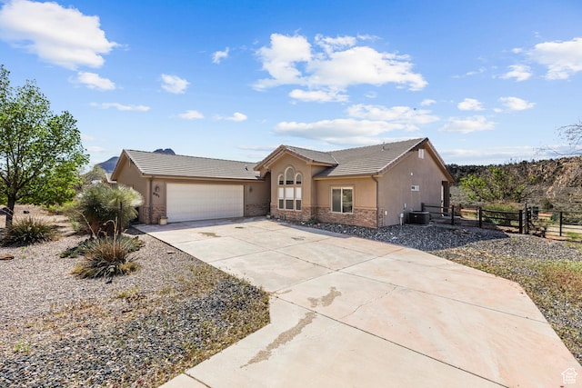 881 W Smithsonian Way, Apple Valley, UT 84737 - ranch-style home featuring stucco siding, fence, a tiled roof, and an attached garage
