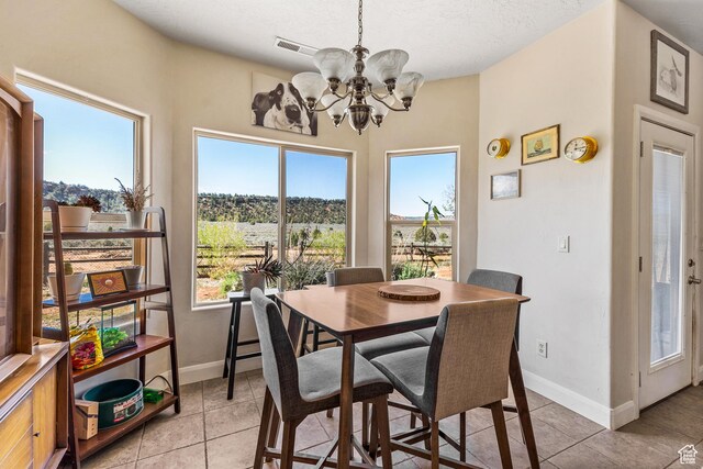 881 W Smithsonian Way, Apple Valley, UT 84737 - dining space with a chandelier, healthy amount of natural light, light tile patterned floors, and a textured ceiling