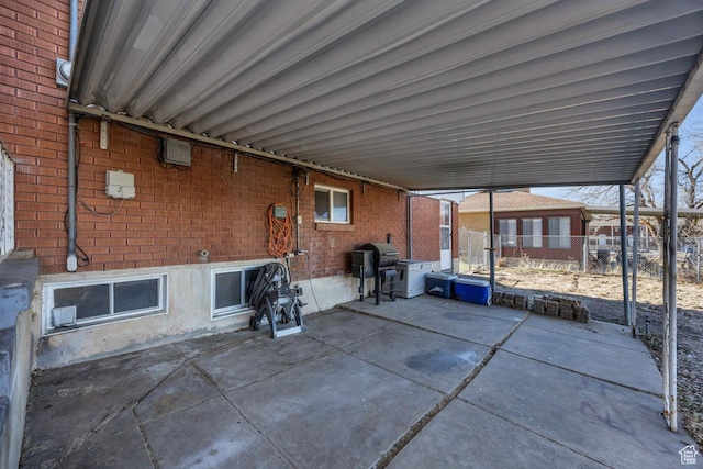 view of patio with fence and a grill