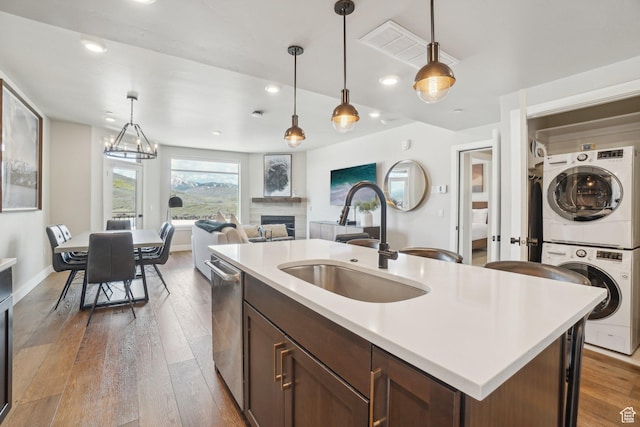 909 W Peace Tree Trl Unit 513, Kamas, UT 84036 - kitchen with stacked washing machine and dryer, a sink, dishwasher, light countertops, and decorative light fixtures