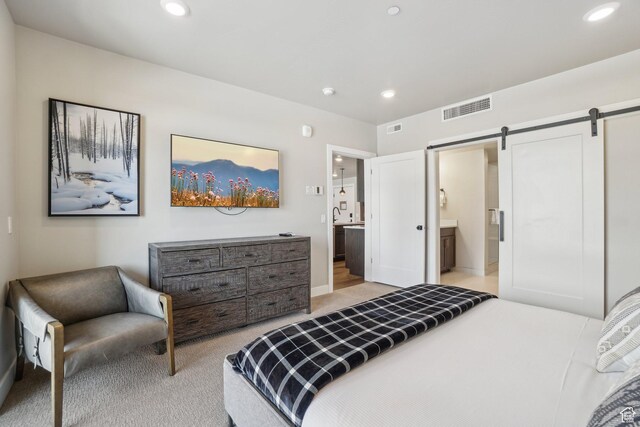909 W Peace Tree Trl Unit 513, Kamas, UT 84036 - bedroom with a barn door, light colored carpet, recessed lighting, connected bathroom, and baseboards