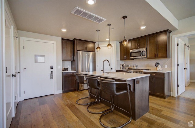 909 W Peace Tree Trl Unit 513, Kamas, UT 84036 - kitchen featuring stainless steel appliances, a sink, dark brown cabinets, and recessed lighting