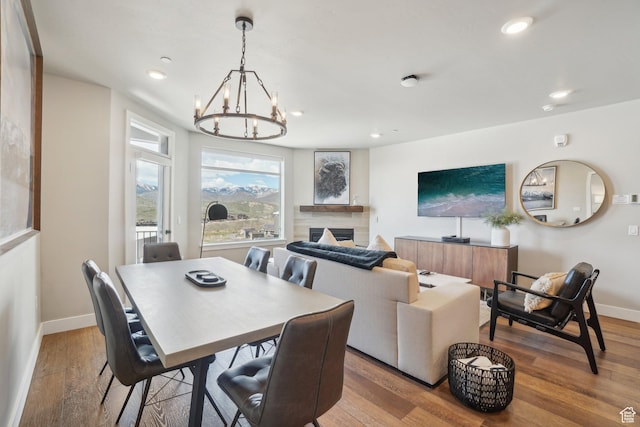 909 W Peace Tree Trl Unit 513, Kamas, UT 84036 - dining space featuring baseboards, a chandelier, recessed lighting, wood finished floors, and a fireplace