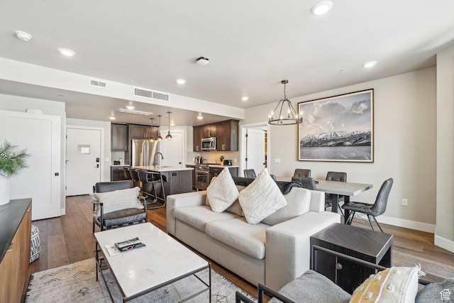 909 W Peace Tree Trl Unit 513, Kamas, UT 84036 - living area featuring a chandelier, hardwood / wood-style floors, baseboards, and recessed lighting