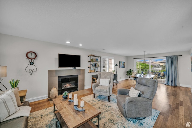 1845 W Canyon Vw Unit 1509, St George, UT 84770 - living room featuring a tiled fireplace, wood finished floors, baseboards, and recessed lighting