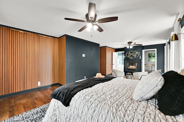 3348 E Stonehill Ln, Cottonwood Heights, UT 84121 - bedroom featuring wood-type flooring, a glass covered fireplace, ceiling fan, and baseboards